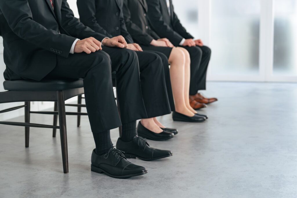 men and women lined up for job interviews