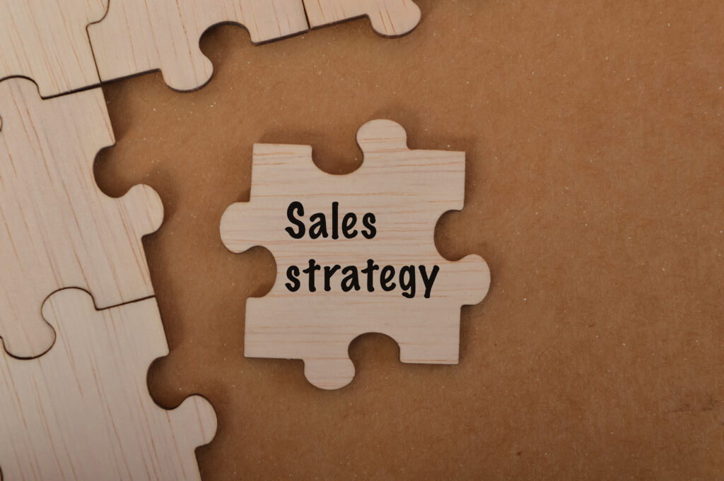 "Sales Strategy" word written on jigsaw puzzle.